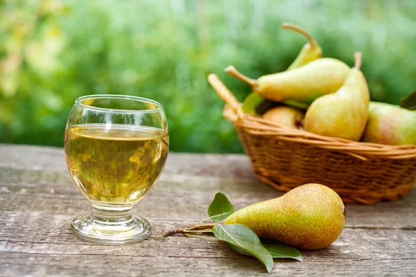 Pear juice and fresh pears on table