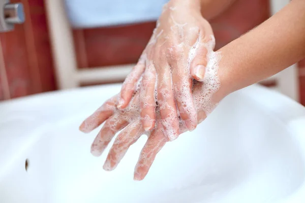 Soapy hands cleaning above the sink — Stock Photo, Image