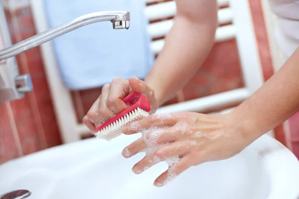 Hand cleaning with brush in bathroom — Stock Photo, Image