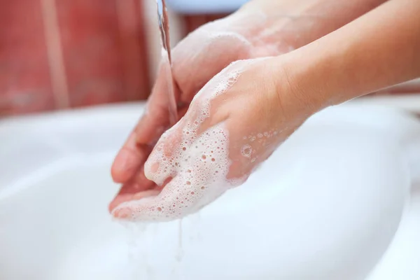 Cleaning soapy hands with running water — Stock Photo, Image