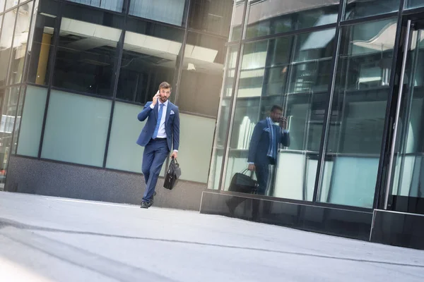Busy man going to work and talking on phone