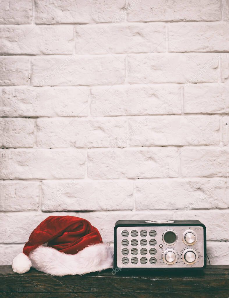 Radio receiver with Santa hat. Holidays congratulation in mass m