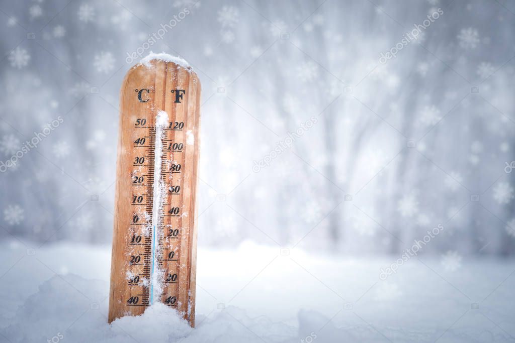 Thermometer with Celsius scale placed in a fresh snow 