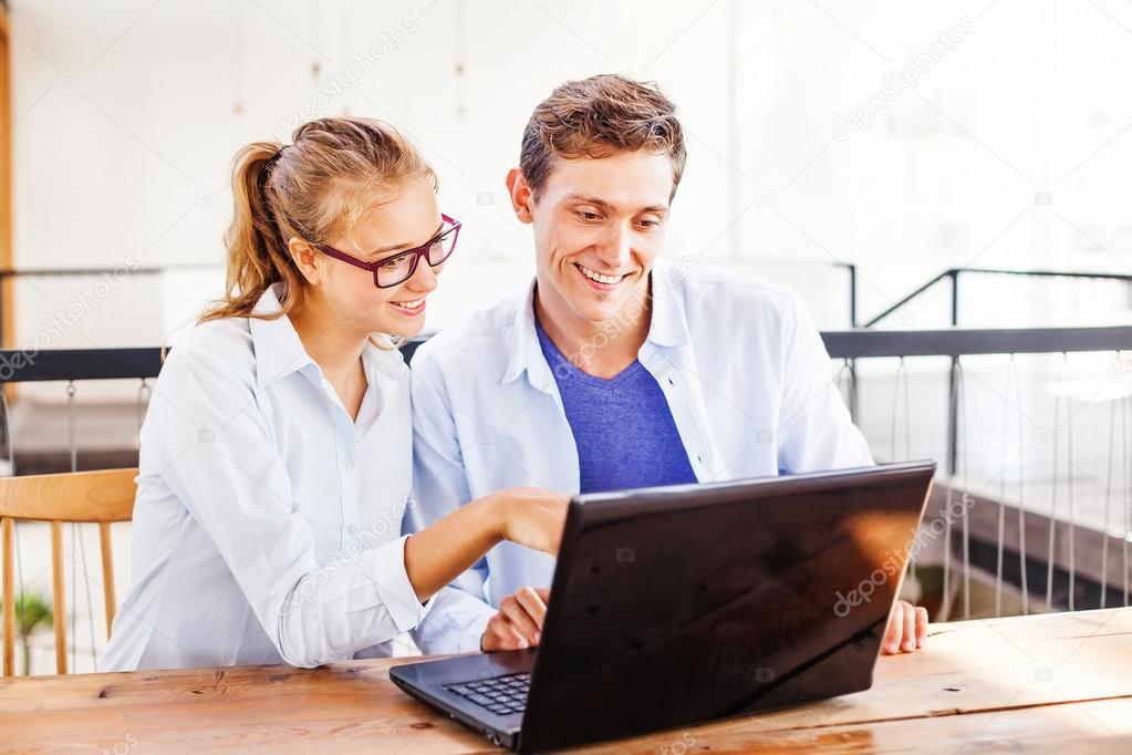 two people working on laptop together