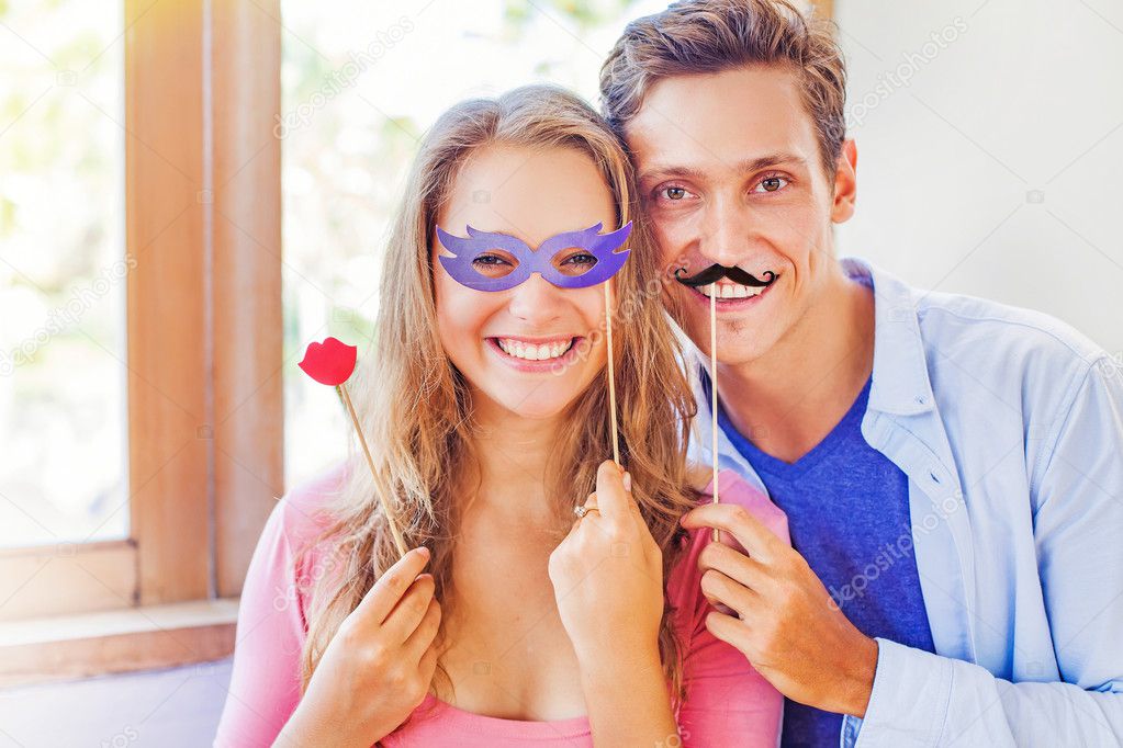 Couple posing with hipster masks