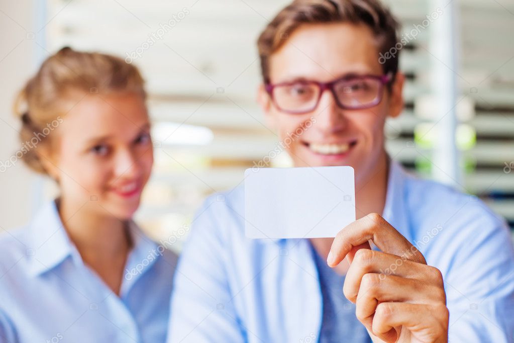 man and woman holding blank business card