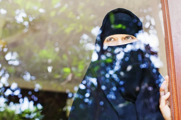 Muslimská žena při pohledu přes okno — Stock fotografie