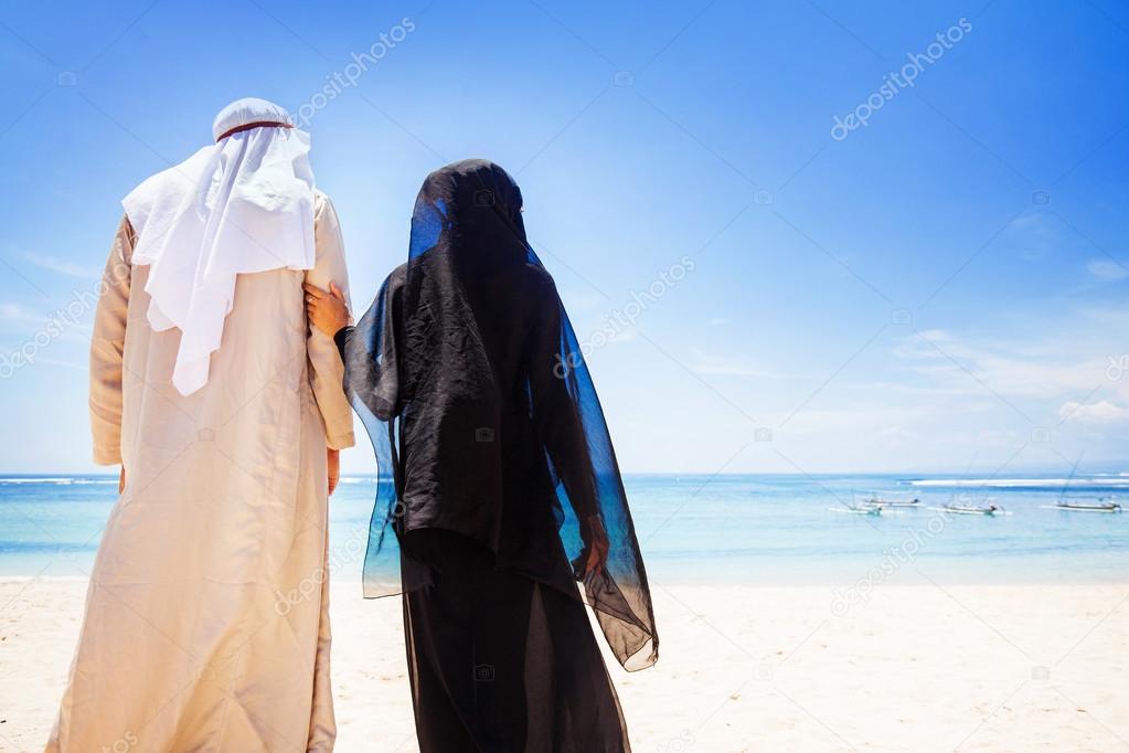 muslim couple on beach  