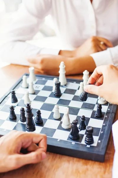 businesspeople playing chess in office