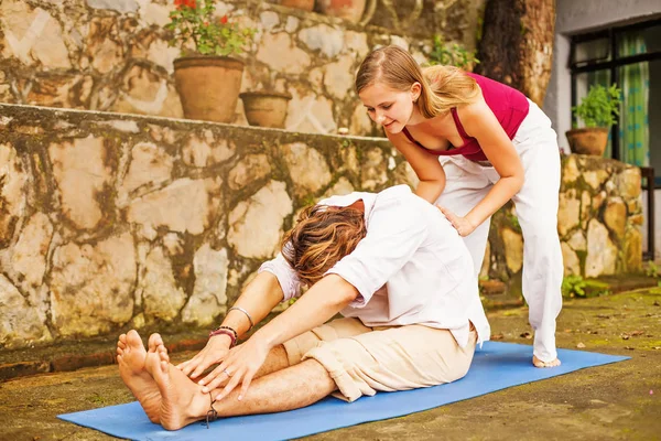 Man and  woman doing yoga — Stock Photo, Image