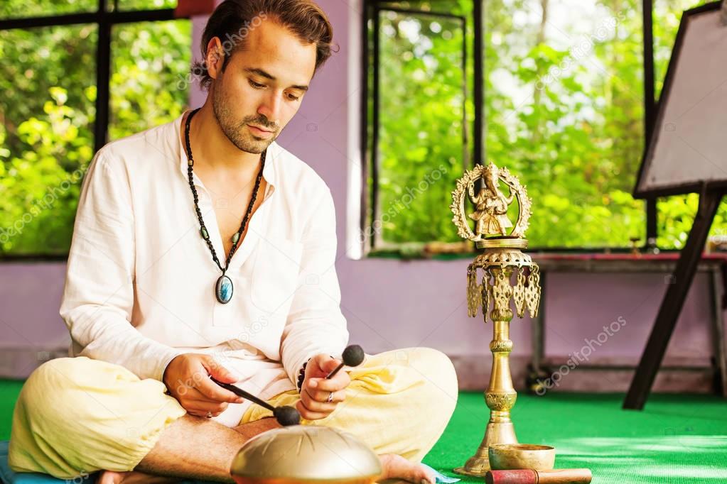 mixed race man playing mantras 