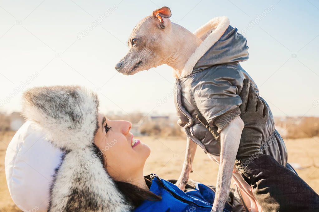 woman playing with her dog  