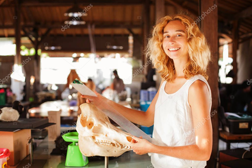 female paleontologist examining a skull 