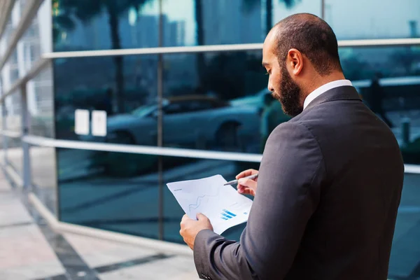 Young Middle Eastern Businessman Reading Fund Reports — Stock Photo, Image