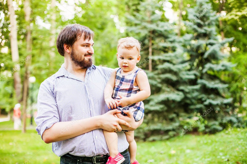 happy father holding girl outdoors 