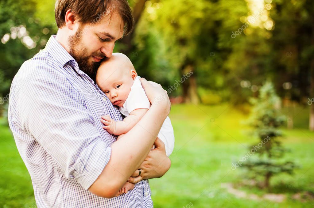 young father holding baby girl