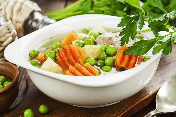 Chicken soup with green peas — Stock Photo, Image