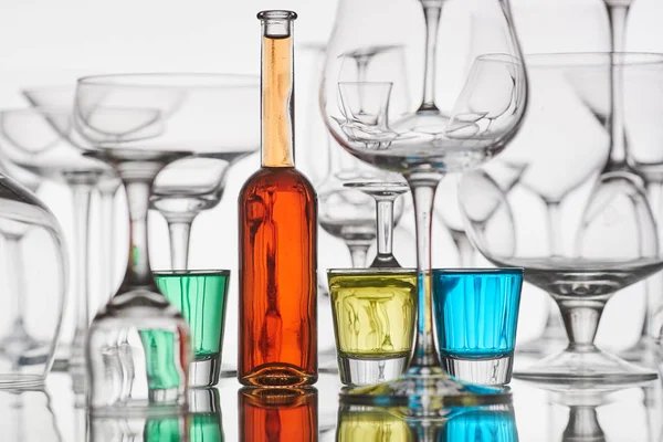 glasses with colorful drinks on a white background