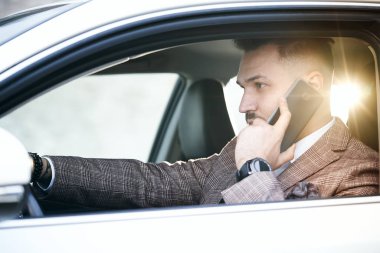 Dizüstü bilgisayarı ve telefonu olan bir adam.
