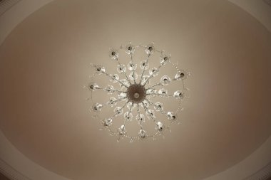 crystal chandeliers with lots of lights in a restaurant