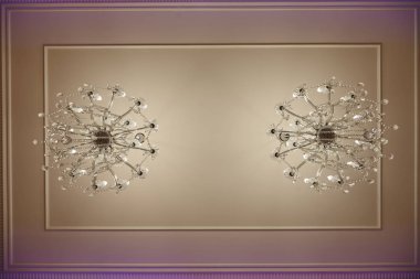  crystal chandeliers with lots of lights in a restaurant