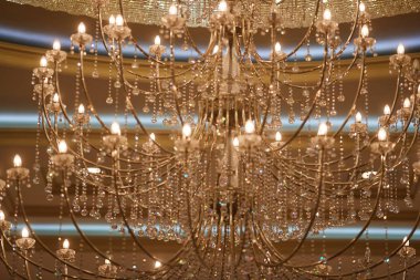 crystal chandeliers with lots of lights in a restaurant