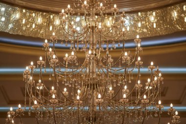  crystal chandeliers with lots of lights in a restaurant