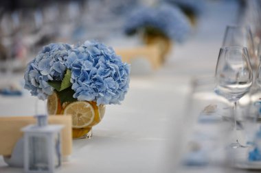 bouquets of various flowers as a decoration on wedding tables