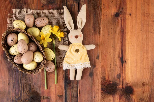Easter background with vintage easter bunny decoration over old wood. Copy space, top view — Stock Photo, Image