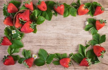 Ahşap arka plan üzerinde yaprakları ile taze çilek. Üstten Görünüm, kopya alanı