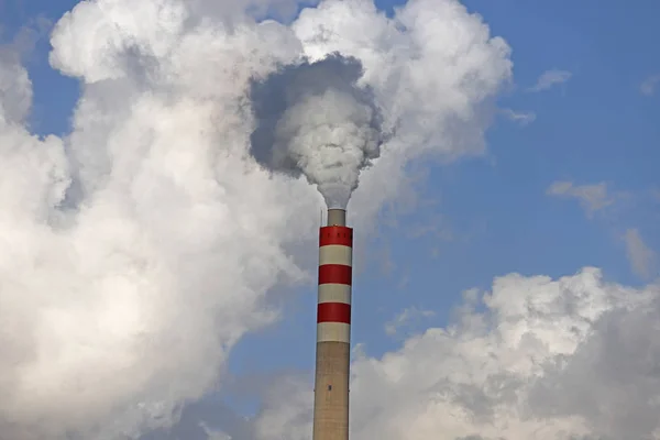 Factory chimneys producing energy and producing smoke.