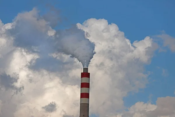 Factory chimneys producing energy and producing smoke.