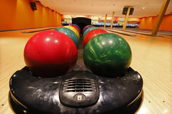 Bowling alley, colored balls in the bowling alley.