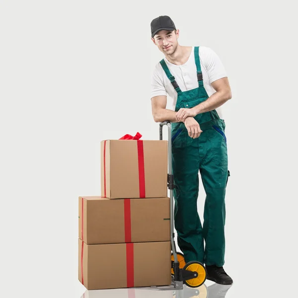 Courier standing with packages and gifts — ストック写真