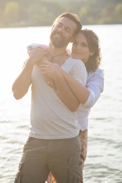 Schönes Paar umarmt sich am See — Stockfoto