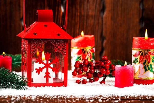Christmas and New Year background with Christmas candle lantern and Christmas tree branches, snow and decorations, wooden wall behind. Free space — Stock Photo, Image