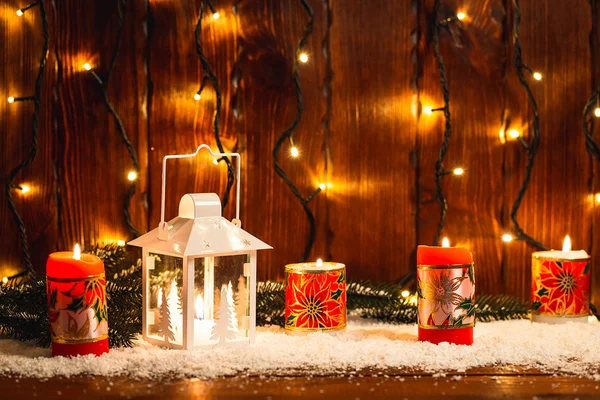 Christmas candle lantern and Christmas tree branches, snow, snowflake and decorations on bokeh background blurred lights. Free space — Stock Photo, Image