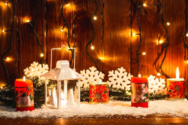 Christmas candle lantern and Christmas tree branches, snow, snowflake and decorations on bokeh background blurred lights. Free space — Stock Photo, Image