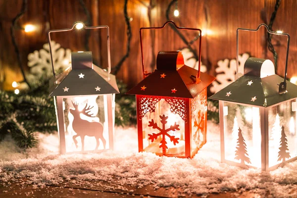 Christmas candle lantern and Christmas tree branches, snow, snowflake and decorations on bokeh background blurred lights. Free space — Stock Photo, Image