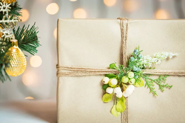 A Christmas tree decorated snowflakes and a garland with gift box on the background of a bokeh and white boards. Merry Christmas, ideas for postcards for winter holidays — Stock Photo, Image