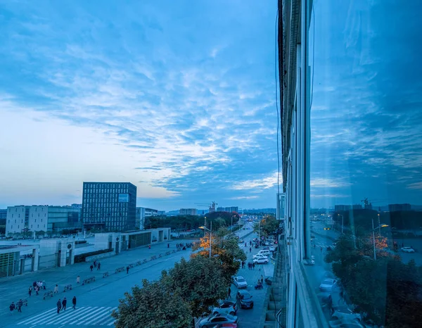 City scenery under the setting sun.  The sky after sunset in the evening was covered with clouds.  The city\'s architectural streets and sky perfectly match