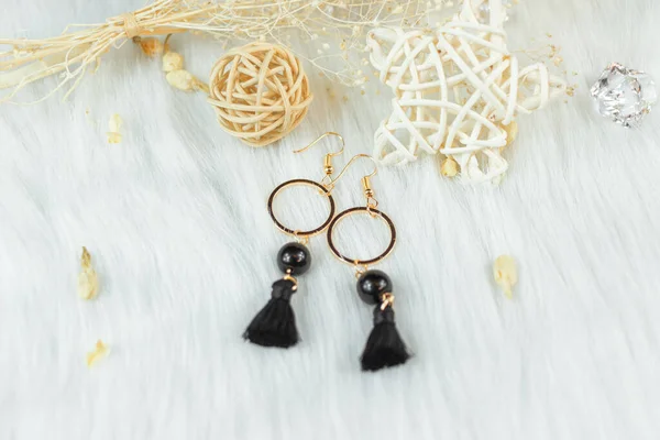 These earrings are handmade by us.Black fringed decoration.Nobility and grace.The earrings are made of metal and the color is like gold.This rattan ornament, shaped like a star or ball, matches perfectly.