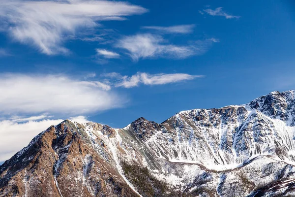 Snow-capped mountain peak, glacier against blue sky