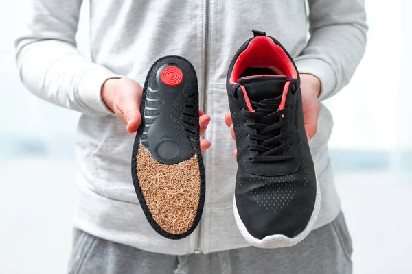 Orthopedic insoles for sports shoes. Treatment and prevention of flatfeet and orthopedic foot diseases. Foot care, feet comfort. Health care, wearing comfortable shoes