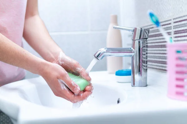 https://st3.depositphotos.com/18922288/33068/i/450/depositphotos_330685912-stock-photo-woman-washing-hands-soap-faucet.jpg