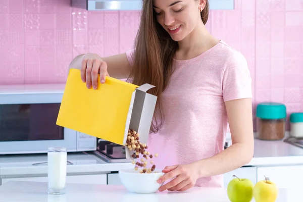 Smiling Happy Woman Pouring Frosted Chocolate Balls Out Cereals Box — Stock Photo, Image
