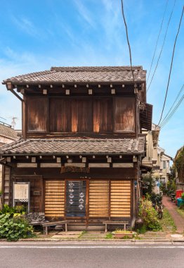tokyo, japan - march 30 2020: Ancient Japanese Sake factory wooden house in the Hatsunecho district of Meiji era rehabilitated into retro Old-Fashioned Exhibition space Kourinsha in the quiet nostalgic neighbourhood of the old town of Yanaka Ginza. clipart