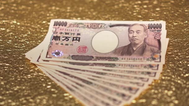 黄金の紙に現金10万円のクローズアップスライドビデオ. — ストック動画