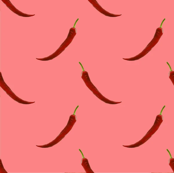 Red peppers on the pink background repetition