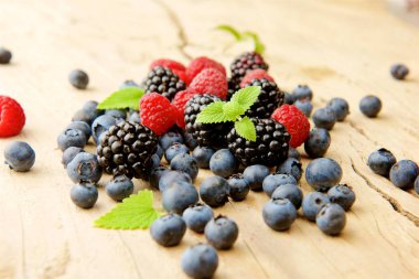 fresh berries and blueberries on a wooden background